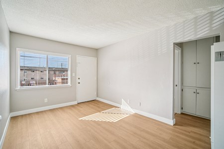 A room with a window and a door.